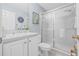 A calming bathroom with white vanity, framed mirror and glass shower door provides a clean and updated space at 311 1St Sw Ave, Largo, FL 33770