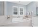 Bright bathroom featuring soaking tub with white tile surround, shuttered windows and sleek fixtures at 311 1St Sw Ave, Largo, FL 33770