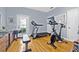 Bright workout room with hardwood floors and exercise equipment, including a treadmill and exercise bike at 311 1St Sw Ave, Largo, FL 33770