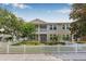 Inviting two-story home with charming white picket fence and manicured landscaping at 311 1St Sw Ave, Largo, FL 33770