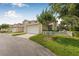 Townhouse with a two-car garage, adjacent to a well-maintained lawn and small tree at 311 1St Sw Ave, Largo, FL 33770