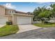 Two-car garage with a clean white door and a neat driveway offers convenience and curb appeal at 311 1St Sw Ave, Largo, FL 33770