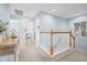 Second floor hallway featuring gray carpet and wooden banister at 311 1St Sw Ave, Largo, FL 33770