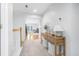 Upstairs hallway with console table and view into living room at 311 1St Sw Ave, Largo, FL 33770