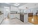 Bright kitchen showcases white cabinets, granite countertops, stainless steel appliances and tile floors at 311 1St Sw Ave, Largo, FL 33770