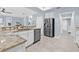 Bright kitchen showcases white cabinets, granite countertops, stainless steel appliances and tile floors at 311 1St Sw Ave, Largo, FL 33770