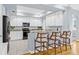 Bright kitchen features white cabinets, granite countertops, stainless steel appliances and a breakfast bar at 311 1St Sw Ave, Largo, FL 33770