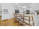 Charming kitchen featuring wooden floors, granite countertops, and a breakfast bar with three chairs at 311 1St Sw Ave, Largo, FL 33770