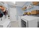 Functional laundry room with shelving, washer, dryer, and storage at 311 1St Sw Ave, Largo, FL 33770