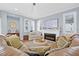 Inviting living room featuring a fireplace, large sofa, neutral decor, and ample lighting at 311 1St Sw Ave, Largo, FL 33770