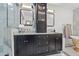 The bathroom features marble countertops, cabinetry and tiled walls with a glass door shower at 3114 W Granada St, Tampa, FL 33629