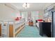 Cozy bedroom featuring twin beds, a baseball theme, and a vibrant blue and white patterned rug at 3114 W Granada St, Tampa, FL 33629
