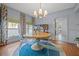 Elegant dining room featuring a round table, stylish chandelier, and hardwood floors at 3114 W Granada St, Tampa, FL 33629