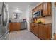 A well-lit kitchen boasts custom wood cabinetry, stone tile backsplash, black countertops and stainless steel appliances at 3114 W Granada St, Tampa, FL 33629