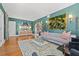Well-decorated living room boasts hardwood floors, unique artwork, stylish furnishings, and designer lighting at 3114 W Granada St, Tampa, FL 33629