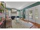 The elegant living room features a fireplace, a chic seating arrangement, and hardwood flooring at 3114 W Granada St, Tampa, FL 33629