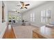 Bright living room features hardwood floors, neutral-toned furniture, ceiling fans, and natural light at 3114 W Granada St, Tampa, FL 33629