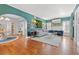 Spacious and open living area featuring hardwood floors, stylish furniture, an arched doorway, and designer accents at 3114 W Granada St, Tampa, FL 33629