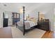 This bedroom features a four-poster bed, decorative lighting and a fireplace with black painted brick at 3114 W Granada St, Tampa, FL 33629