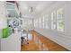 Bright office space features hardwood floors, multiple windows with shutters and ample storage shelving at 3114 W Granada St, Tampa, FL 33629