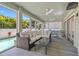 Enclosed sunroom featuring comfortable seating, ceiling fans, and backyard views at 3114 W Granada St, Tampa, FL 33629
