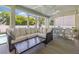 Enclosed patio with comfortable seating, ceiling fans, and views of the lush backyard at 3114 W Granada St, Tampa, FL 33629