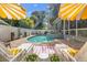 Backyard oasis with a sparkling pool, lounge seating, and privacy fencing at 3114 W Granada St, Tampa, FL 33629