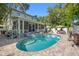 Inviting backyard pool with a spa, patio, and a charming screened porch perfect for outdoor relaxation at 3114 W Granada St, Tampa, FL 33629