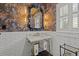 Elegant powder room features a marble sink, dark floral wallpaper, and designer fixtures at 3114 W Granada St, Tampa, FL 33629