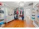 Spacious walk-in closet with custom shelving, hardwood floors, and a crystal chandelier at 3114 W Granada St, Tampa, FL 33629