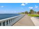 Scenic waterfront view featuring a sidewalk with blue sky above and palm trees at 3114 W Granada St, Tampa, FL 33629