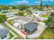 Aerial view of fenced backyard featuring a screened-in patio, shed and open-air patio at 3145 Domino Dr, Holiday, FL 34691