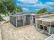 Aerial view of backyard with paver patio, screened-in lanai, and utility area at 3145 Domino Dr, Holiday, FL 34691