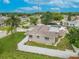 Aerial view of home in a fenced backyard with grass, greenery and shed with an inviting stone walkway at 3145 Domino Dr, Holiday, FL 34691