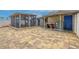 Backyard with paver patio, screened-in lanai, utility area, and white fencing at 3145 Domino Dr, Holiday, FL 34691