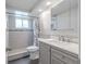 Bathroom featuring gray vanity, tiled shower, and modern fixtures at 3145 Domino Dr, Holiday, FL 34691