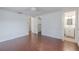 Spacious bedroom with hardwood floors, ceiling fan, and walk-in closet is connected to an ensuite bathroom at 3145 Domino Dr, Holiday, FL 34691