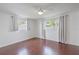 Bright bedroom with hardwood floors, large windows, and decorative curtains at 3145 Domino Dr, Holiday, FL 34691