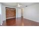 Bedroom with hardwood floors, ceiling fan, and closet with wood wall accents at 3145 Domino Dr, Holiday, FL 34691
