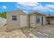 View of backyard, including a shed and exterior entrance to the home, paved in brick and stone at 3145 Domino Dr, Holiday, FL 34691