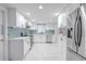 Modern kitchen featuring white cabinets, stainless steel appliances, and stylish tile flooring at 3145 Domino Dr, Holiday, FL 34691