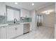 Lovely eat-in kitchen with bright natural light, white shaker cabinets and stainless steel appliances at 3145 Domino Dr, Holiday, FL 34691