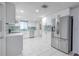 Spacious renovated kitchen features stainless steel appliances, plenty of cabinets, and white tile floors at 3145 Domino Dr, Holiday, FL 34691