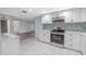 Updated kitchen with stainless steel appliances, bright white cabinets, and durable countertops at 3145 Domino Dr, Holiday, FL 34691