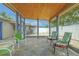 Screened-in lanai with seating, a ceiling fan, and paver patio at 3145 Domino Dr, Holiday, FL 34691