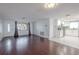 Bright living room adjacent to a kitchen with white cabinetry and stainless steel appliances at 3145 Domino Dr, Holiday, FL 34691