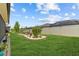Large grassy backyard showcasing a garden with a beautiful Weeping Willow and a white vinyl fence at 31921 Magna Gulf Loop, San Antonio, FL 33576