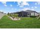 Beautiful backyard with a screened-in lanai and a professionally landscaped garden area at 31921 Magna Gulf Loop, San Antonio, FL 33576