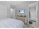 Bedroom boasts a TV, ensuite bathroom and closet for ample space and style at 31921 Magna Gulf Loop, San Antonio, FL 33576