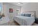 Cozy bedroom featuring a comfortable bed with plush pillows, a ceiling fan, and a serene, minimalist aesthetic at 31921 Magna Gulf Loop, San Antonio, FL 33576